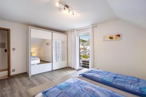 a bedroom with a bed and a large window at Ferienwohnung Niemeier in Brilon