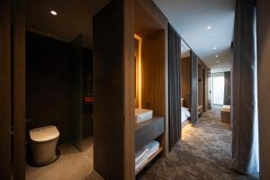 a bathroom with a toilet and a sink at Hotel Editions Mokpo in Mokpo +95 photos