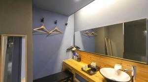 a bathroom with a sink and a mirror at 747 Motel in Gimcheon +31 photos