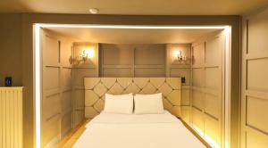 a bed in a room with two pillows on it at 747 Motel in Gimcheon