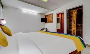 a white bedroom with a white bed in a room at Itsy Hotels Dew Dreams in Cochin +22 photos