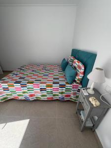 a bedroom with a bed and a table with a lamp at Beau séjour in Pedreguer +2 photos