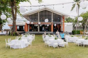 a group of tables and chairs in front of a building at Tolani Resort Koh Samui in Lamai +92 photos