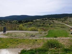a winding road in a field with mountains in the background at Apartamento Valdenieve VUTE-15-041 in Valdelinares