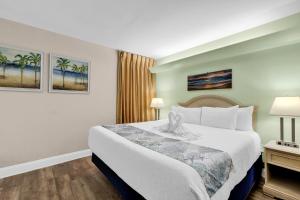 a hotel room with a bed in a room at Hosteeva Atlantica Oceanfront Condo in Myrtle Beach