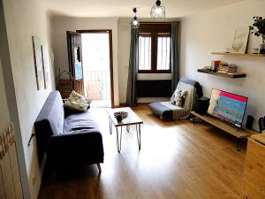 a living room with a couch and a table at Apartamento Valdenieve VUTE-15-041 in Valdelinares
