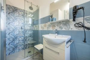 a bathroom with a sink and a shower at Moon - Rooms in Quartu SantʼElena +43 photos