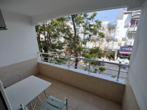 a balcony with a table and chairs and a window at Datça Stayinn Otel in Datca