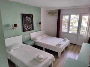 a room with two beds and a window at Datça Stayinn Otel in Datca +36 photos