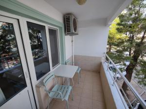 a balcony with chairs and a table and a heater at Datça Stayinn Otel in Datca