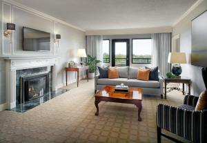 a living room with a couch and a fireplace at Omni Shoreham Hotel Washington DC in Washington, D.C.