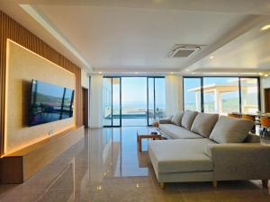 a living room with a couch and a flat screen tv at Ocean Big Tiger Villa-6 Bedrooms with Ocean View Private Pool in Nathon Bay