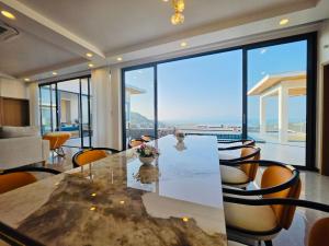 a dining room with a table and chairs with a view at Ocean Big Tiger Villa-6 Bedrooms with Ocean View Private Pool in Nathon Bay