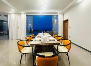 a dining room with a long table with orange chairs at Ocean Big Tiger Villa-6 Bedrooms with Ocean View Private Pool in Nathon Bay +77 photos