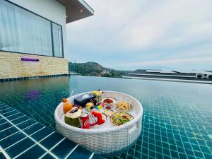 a bowl of food on the edge of a swimming pool at Ocean Big Tiger Villa-6 Bedrooms with Ocean View Private Pool in Nathon Bay