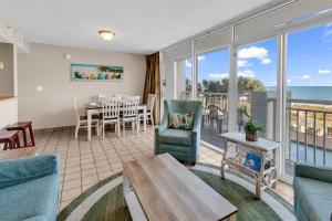 a living room with a view of the ocean at Hosteeva Atlantica Oceanfront Condo in Myrtle Beach