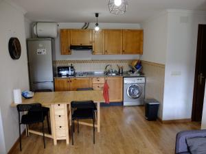 a kitchen with a table and chairs and a refrigerator at Apartamento Valdenieve VUTE-15-041 in Valdelinares