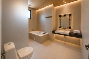 a bathroom with a toilet and a sink and a mirror at Star Villa in Ren'ai +159 photos