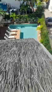 a large umbrella next to a swimming pool at Le Clos des Bains Mauritius in Blue Bay +26 photos