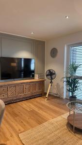 a living room with a large flat screen tv at AMAO-Ivory - Business Apartment - 6 Guests - Parking in Offenburg +13 photos