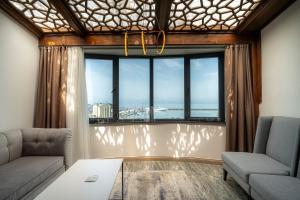 a living room with a large window with a view at Ween Otel in Trabzon