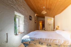 a bedroom with a large bed with a wooden ceiling at Appartement 1 in Sauzet +26 photos