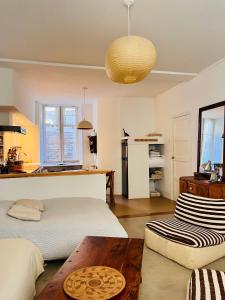 a living room with a bed and a table at Studio à l'entrée de ma maison in Aubusson