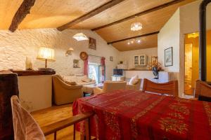 a living room with a table and a dining room at Appartement 1 in Sauzet