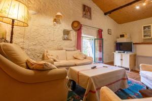 a living room with a couch and a table at Appartement 1 in Sauzet