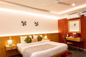 a hotel room with a bed and a desk at Avocado Cottages by Alaya Stays, Coorg in Suntikoppa
