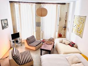 a living room with a couch and a table at Studio à l'entrée de ma maison in Aubusson