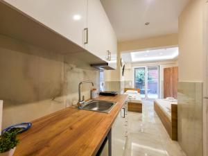 a kitchen with a sink and a counter at ARETI Suites by SDR in Olympic Beach