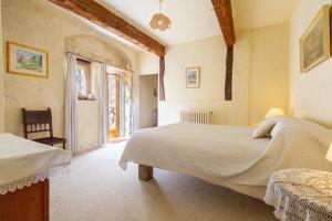 a bedroom with a large bed and a window at Appartement 2 in Sauzet