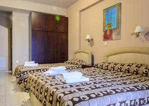 Ліжко або ліжка в номері Hotel Athina