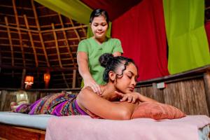 a woman is laying on a bed in a stage at Atremaru Jungle Retreat in Puerto Princesa City