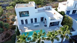 an aerial view of a white house with a swimming pool at Villa Titulabo in Orba