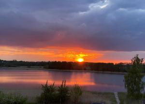 a sunset over a large body of water at Uroczy zakątek in Silice