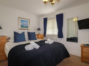 a bedroom with a bed with two towels on it at Treveline in Bodmin