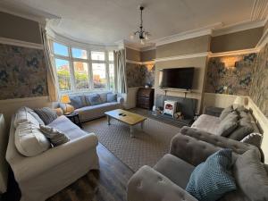 a living room with two couches and a tv at Avalon Lodge in Bridlington