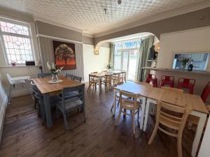 a dining room with wooden tables and chairs at Avalon Lodge in Bridlington