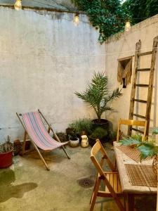 a patio with a chair and a table and a ladder at Studio à l'entrée de ma maison in Aubusson +5 photos