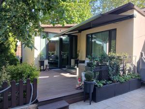 a house with a wooden deck with a fence at Studio'24 - Adults Only in Constanţa