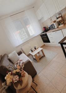 a living room with a couch and a table at Apartman Ivano in Vukovar