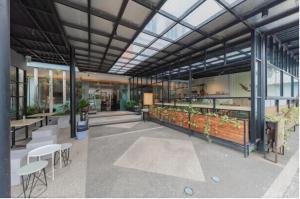 a rendering of a restaurant with tables and chairs at Alqueby Hotel Bandung in Bandung +18 photos