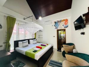 a bedroom with a bed and a chair at Ceylonima Home Stay in Anuradhapura +121 photos