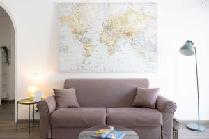 a living room with a couch and a map on the wall at Villa Valentina in Taranto