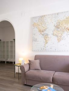 a living room with a couch and a map on the wall at Villa Valentina in Taranto