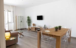 a living room with a table and chairs and a tv at Villa Valentina in Taranto