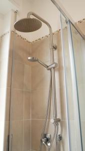 a shower with a shower head in a bathroom at Sky Balcony - Milano Sud- vicino Humanitas e forum Assago in Rozzano