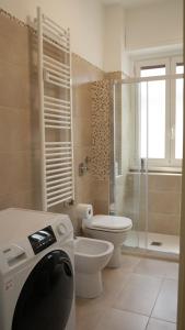 a white bathroom with a toilet and a shower at Sky Balcony - Milano Sud- vicino Humanitas e forum Assago in Rozzano +13 photos